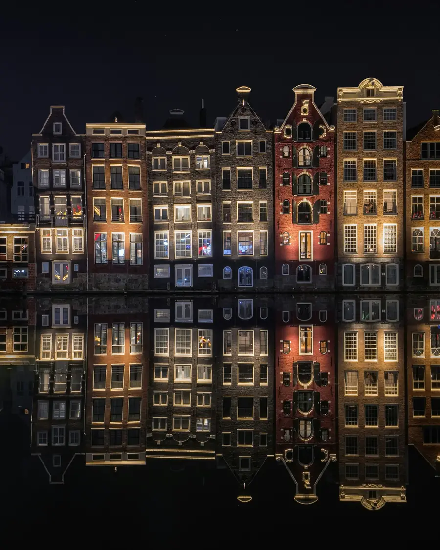Canal houses reflected in the water at night, Amsterdam
